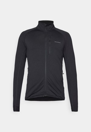 Veste noire à manches longues avec un col montant, fermeture éclair à l'avant et deux poches latérales. Tissu texturé et design ajusté.