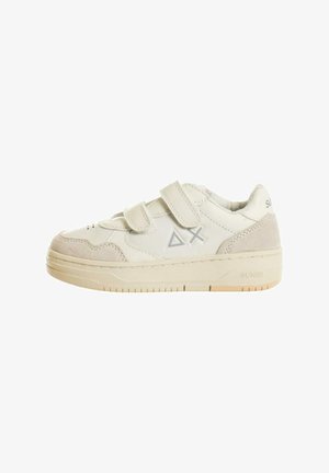 Sneaker bianco con accenti in suede, dotata di due cinturini in Velcro, perforazioni circolari e una suola in gomma testurizzata. Logo visibile sul lato.