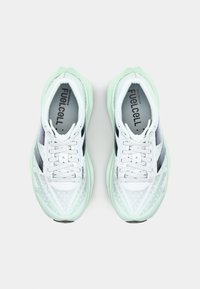 Lightweight athletic shoes in white and mint green, featuring mesh upper, reflective accents, and a cushioned sole with textured pattern.