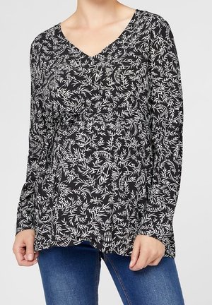 Schwarze Bluse mit langen Ärmeln und V-Ausschnitt, die mit einem weißen Blattmuster versehen ist. Weicher Stoff mit lockerer Passform und gerafften Details an der Taille.