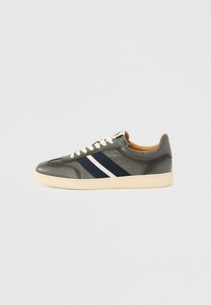 Gray leather sneaker with navy and white stripes, round toe, white laces, cream-colored sole, and a small logo tag on the tongue.