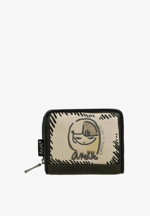 Monedero con una superficie color crema y un diseño de cara de caricatura, cremallera negra y una base oscura que contrasta. El texto dice "Elige brillar."