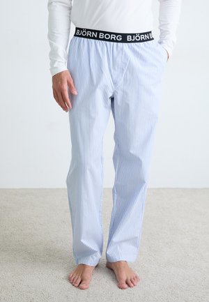 Lichtblauwe en witte gestreepte pyjamabroek met een elastische zwarte tailleband waarop in witte letters "BJÖRN BORG" staat, gemaakt van katoen, met een rechte pasvorm.