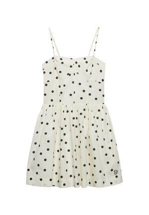 Biała sukienka bez rękawów w czarne groszki, dopasowana góra i rozkloszowany dół. Posiada cienkie ramiączka oraz haftowane logo u dołu.
