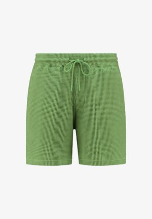 Shorts en tricot vert à mailles avec taille élastique et cordon de serrage ajustable. Dotés de poches latérales et d'un design décontracté.