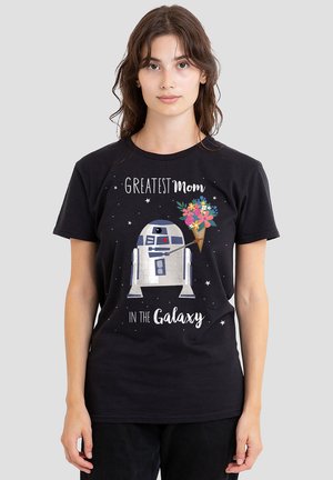 Black cotton t-shirt featuring a graphic of a robot with a bouquet, text reading "Greatest Mom in the Galaxy," and star accents.