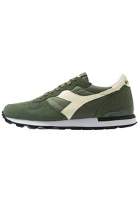 Green and cream athletic shoes with suede and synthetic materials, round toe, classic lace-up design, and a textured rubber outsole.