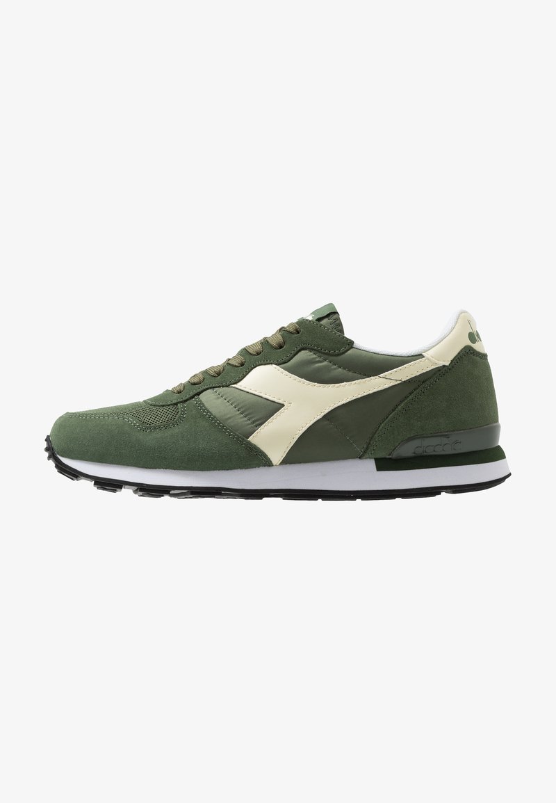 Green and cream athletic shoes with suede and synthetic materials, round toe, classic lace-up design, and a textured rubber outsole.