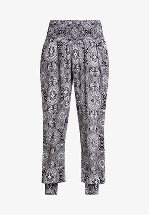 Pantaloni a righe in bianco e nero con vita elastica, vestibilità ampia e caviglie orlate. Il tessuto presenta intricati design floreali.