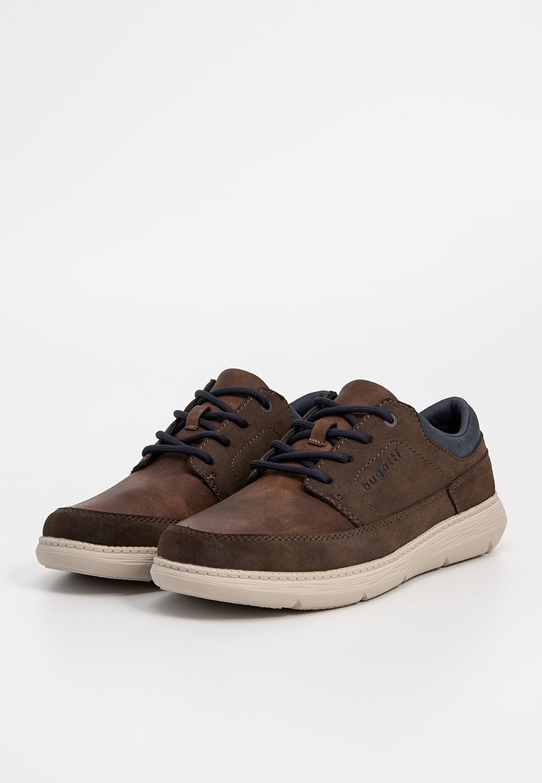 Zapatos de cuero marrón con acentos en azul marino, con punteras redondeadas, parte superior texturizada y suelas de goma beige. Los cordones son de color azul oscuro.