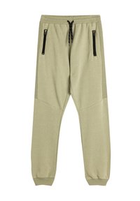 Joggers de un suave color verde oliva claro con perneras ajustadas, cinturilla elástica, cordón y dos bolsillos laterales con cremallera. Textura de tela suave y lisa.