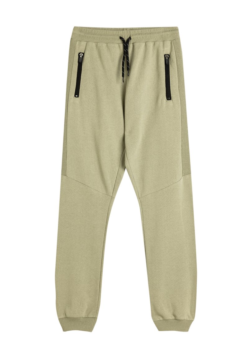Joggers de un suave color verde oliva claro con perneras ajustadas, cinturilla elástica, cordón y dos bolsillos laterales con cremallera. Textura de tela suave y lisa.