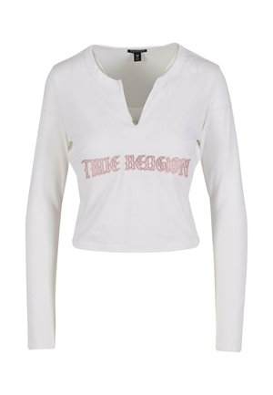 Weißes, langärmeliges, cropped Hemd mit V-Ausschnitt und pink gesticktem "TRUE RELIGION"-Text auf der Brust. Weiches Baumwollmaterial.