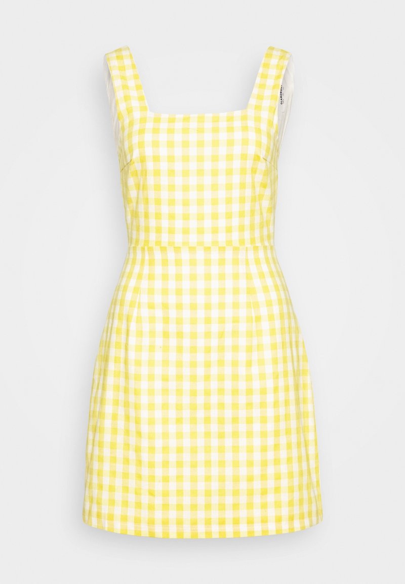 Robe à carreaux vichy jaune et blanc avec un décolleté carré, de larges bretelles, un corsage ajusté et une jupe évasée. Tissu en coton avec une texture lisse.