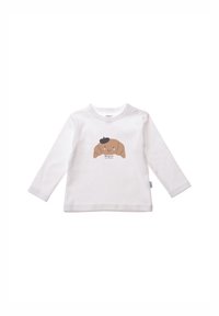 Weißes Langarm-T-Shirt mit einem braunen Cartoon-Hundedesign und einem schwarzen Barett, zentral auf der Vorderseite aufgedruckt.