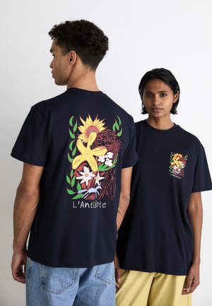 Marineblå bomulds T-shirts med farverige blomstertryk på ryggen og et mindre design på fronten. Løs pasform, korte ærmer.