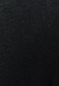 Tessuto di lana nera con una finitura texturizzata, che presenta una superficie morbida e leggermente pelosa e schemi di tessitura consistenti in tutto il materiale.