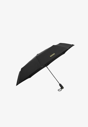 Black umbrella with a textured fabric canopy, gold logo, and black handle. Features a sleek, rounded shape and black metal frame.