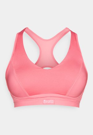 Roza sportska grudnjak s dizajnom s leđa, izrađen od glatke tkanine. Sadrži kontrastni unutarnji sloj i oznaku s logotipom na traci.