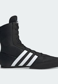 Black high-top Adidas sneaker with white stripes, mesh and suede upper, lace-up closure, and flat rubber sole, shown from the side.