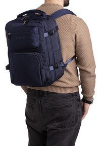 Navy blue backpack made of durable fabric, featuring multiple zippers, adjustable straps, and a top handle for carrying.
