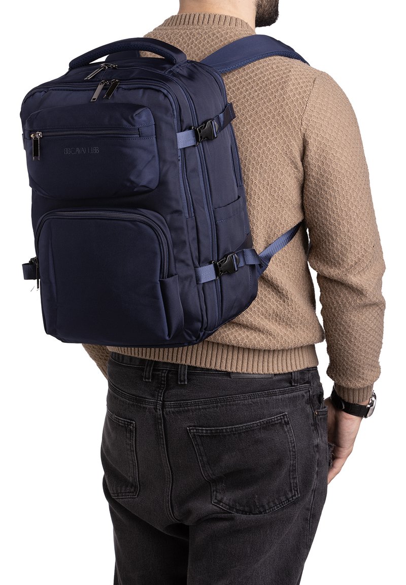 Navy blue backpack made of durable fabric, featuring multiple zippers, adjustable straps, and a top handle for carrying.