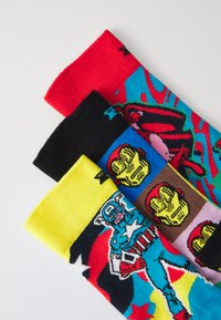 Three pairs of cotton socks: red with a graphic, black with a pattern of yellow gloves, and blue/yellow featuring a superhero design.
