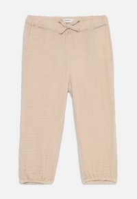 Beige, lette bukser med teksturert stoff. Har en elastisk midje med snor og rynkede mansjetter ved anklene.