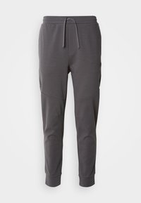 Pantaloni de jogger gri, confecționați dintr-un material moale, cu talie reglabilă prin șnur, prevăzuți cu buzunare laterale și un design cu gleznă conică.