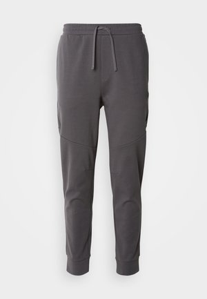Grey jogger pants made from soft fabric with a drawstring waist, features side pockets, and a tapered ankle design.