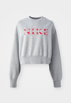 Grey cropped sweatshirt made of cotton blend, featuring ribbed cuffs and hem. Front displays bold red "NIKE" logo with white text below.