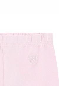 Lichtroze leggings met een elastische tailleband, voorzien van een klein, geborduurd beertje ontwerp op het linkerbeen voor extra detail. Glad textuur.