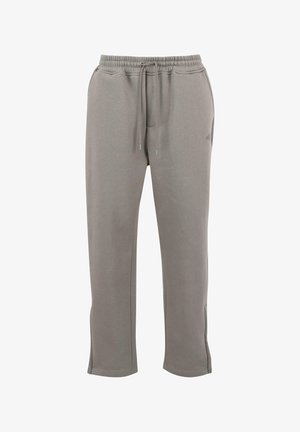 Pantalon de survêtement gris en tissu doux, avec une taille élastique dotée de cordons de serrage, des poches latérales et des ouvertures de jambes fuselées.