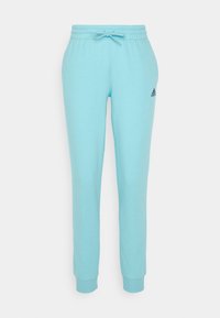 Ljusblå Adidas sweatpants med elastisk midja, dragsko, avslutade anklar och liten svart Adidas-logotyp på höger lår.