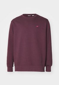 Burgundy sweatshirt i mjuk tyg med rund halsringning och långa ärmar. Har en liten röd Levi's-logga på bröstet.