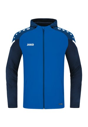 Blauwe sportjacket met een marineblauwe basis, beschikt over een ritssluiting aan de voorkant, een gestructureerde schouder en witte accenten met "JAKO" branding.