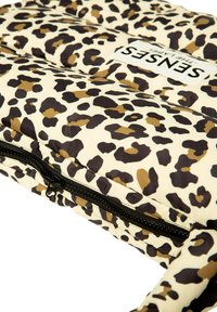Leopard print padded bag in cream, brown, and black. Features a zipper closure and a label with "SENSES" prominently displayed.