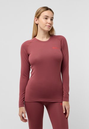 Long-sleeve athletic top in muted mauve, ribbed texture, with contrasting orange logo on left chest. Pairing with matching fitted leggings.