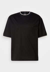 Camiseta de algodón negra con mangas cortas, un escote redondo y un acabado en blanco contrastante en el cuello y los bordes de las mangas.