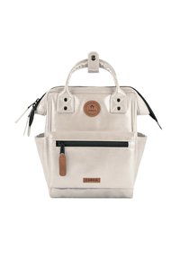 Metallic silver backpack with black accents, dual top handles, and a zippered front pocket. Features logo patch and snap button closure.