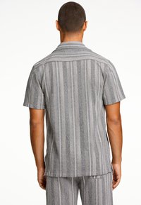 Korte mouw shirt met een achteraanzicht in lichtgrijze en donkergrijze verticale strepen, gemaakt van gestructureerde stof met een gespreide kraag.