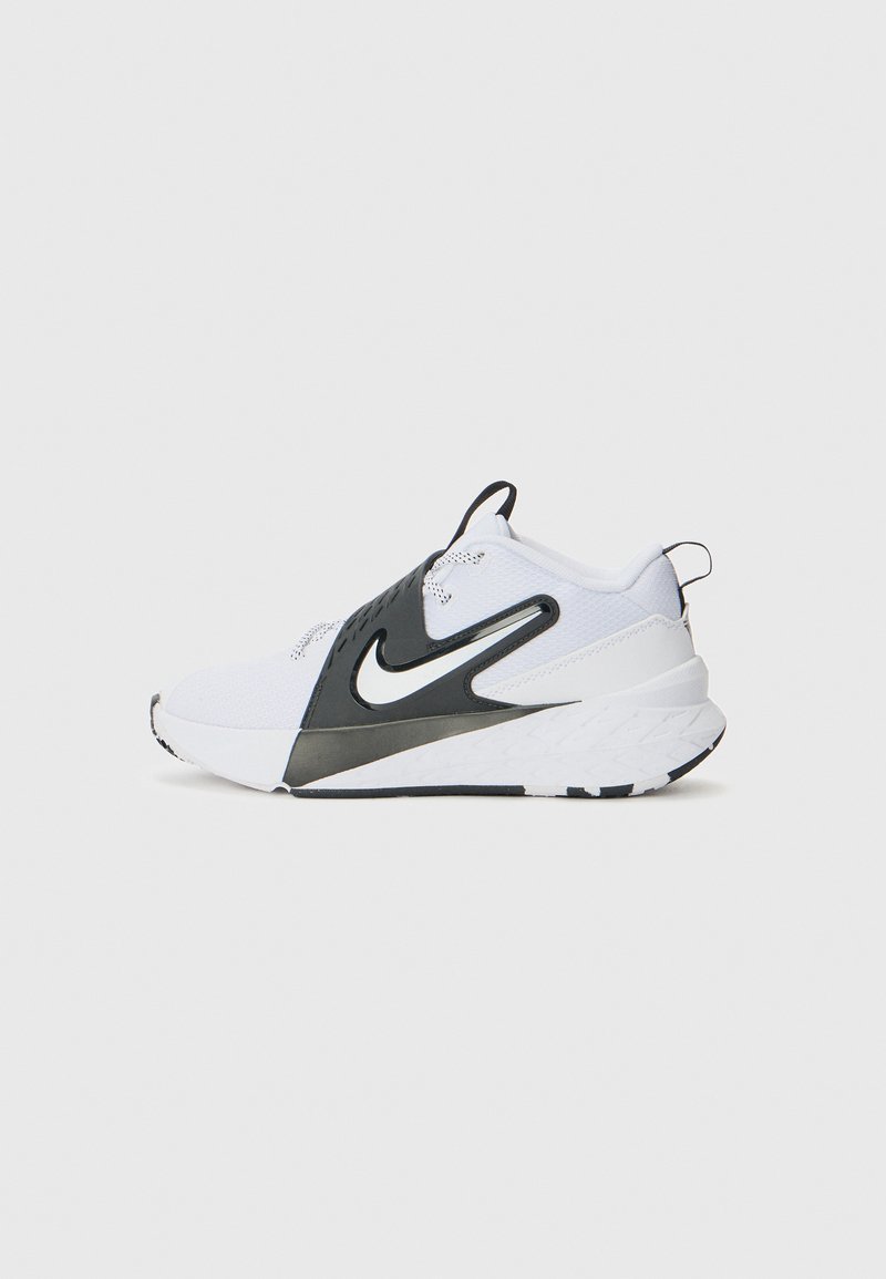 Chaussure de sport blanche avec des accents noirs, tige en maille texturée, semelle blanche épaisse et logo Nike. Dispose d'une languette de traction à l'arrière.