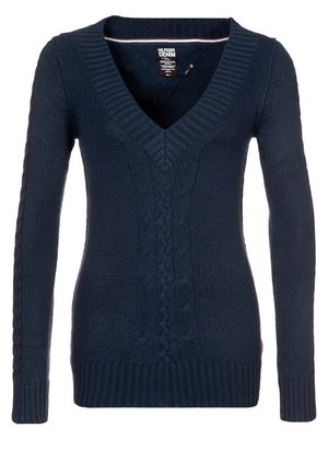 Pull en tricot bleu marine avec un col en V, arborant des motifs en côte et des poignets et un ourlet à bords côtes. Manches longues et silhouette ajustée.