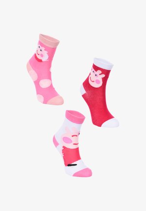 Drei Paare Kindersocken: pink mit Pünktchen, rot mit einem Charakter und eine weiße Basis mit pinken Akzenten, alle aus weicher Baumwolle.