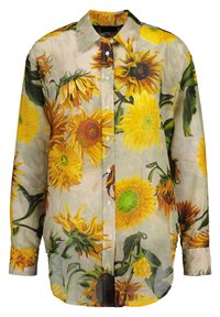 Langærmet skjorte med knapper lavet af gennemsigtigt stof, prydet med et levende solskinsblomstermotiv i gult og brunt på en lys beige baggrund.