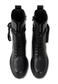 Czarne skórzane buty wojskowe o gładkim wykończeniu, zawiązywane na sznurowadła i z bocznym zamkiem błyskawicznym. Posiadają wysoką cholewkę oraz teksturowaną gumową podeszwę.