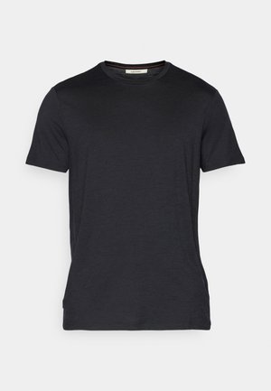 Black short-sleeve t-shirt made of a soft, textured fabric. Features a crew neck and subtle stitching accents along the neckline.