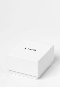 Weißer quadratischer Kasten aus festem Material, mit einem aufgedruckten schwarzen Logo "CHRIST" auf dem Deckel, glatte Textur und sauberes Design.