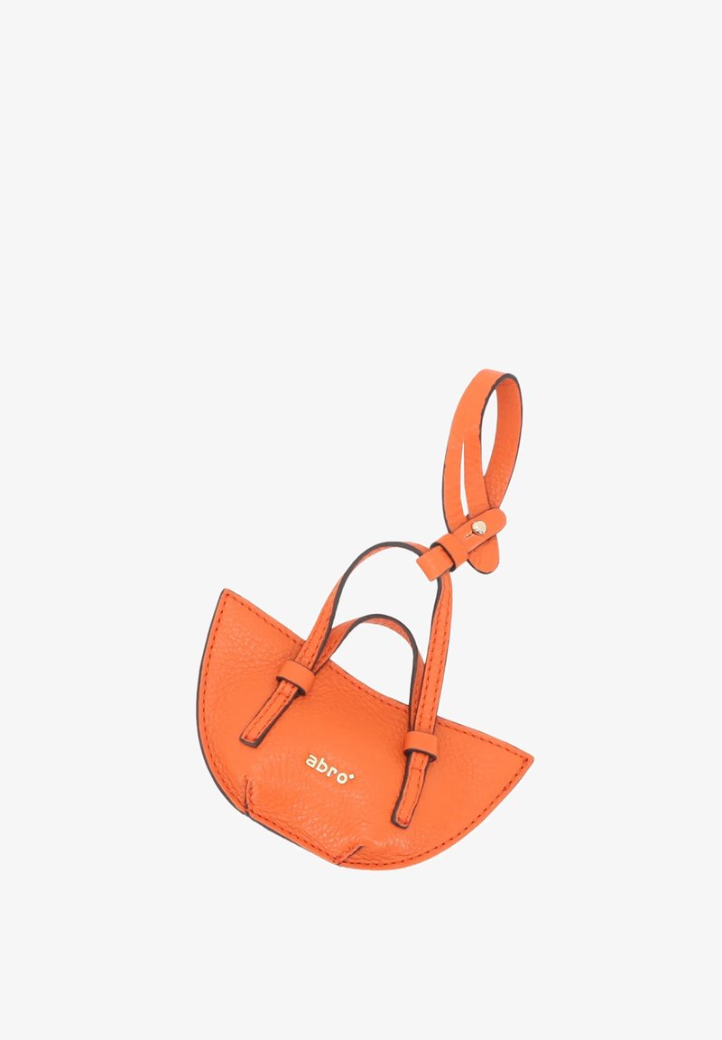 Orange leather mini handbag with a curved shape, two short straps, and a small gold logo. Textured finish and reinforced stitching details.