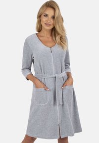 Rochie gri cu fermoar, cu mâneci trei sferturi, talie accentuată cu o curea, două buzunare frontale și o textură moale.